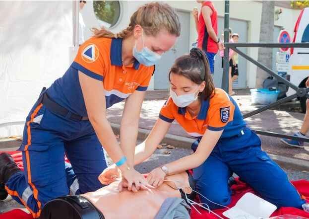 The Practical Benefits of CPR and First Aid Certifications 1 Two woman practicing for first add certification