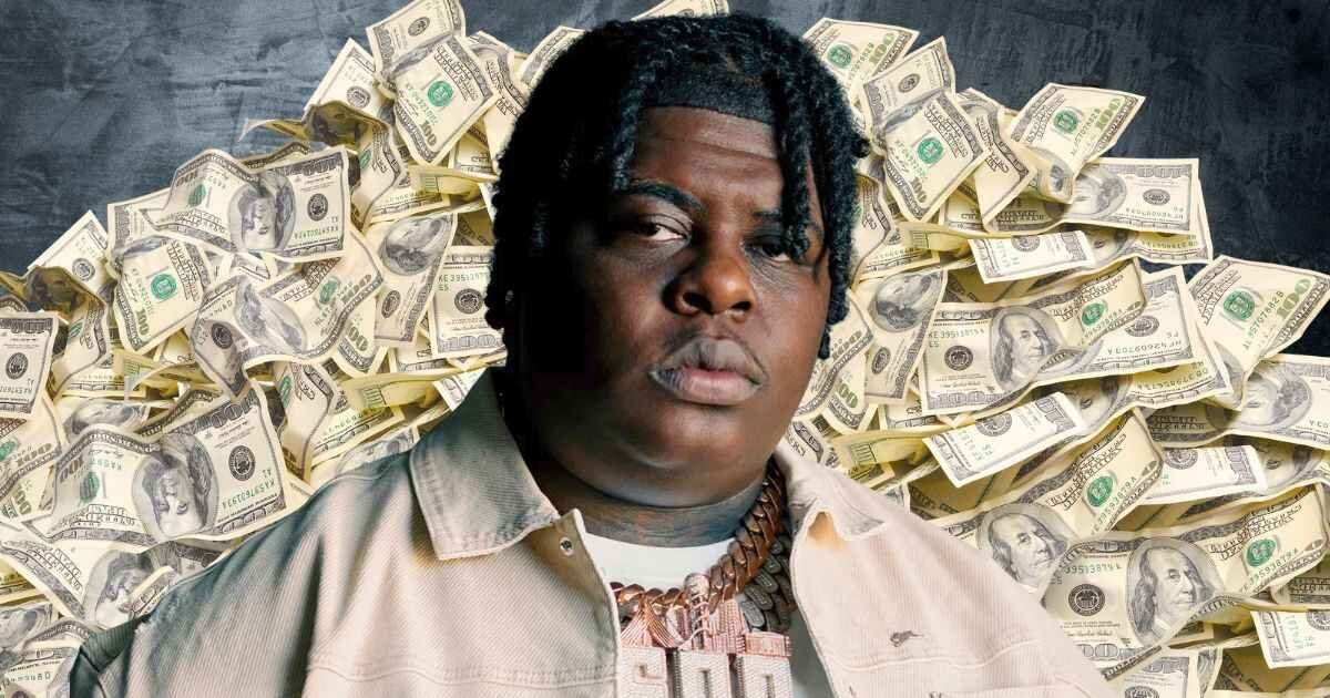 BigXthaPlug Net Worth Revealed: In background a lot of dollars note and bigxthaPlug is in center of