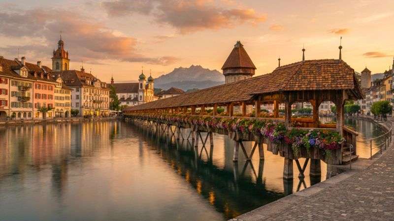 Chapel Bridge over the Reuss River in Lucerne at sunset.