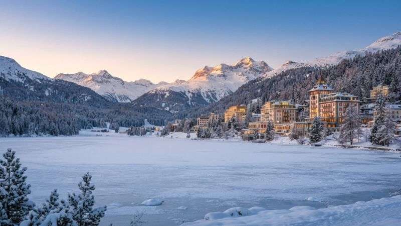 Frozen Lake St. Moritz surrounded by luxury hotels in winter.